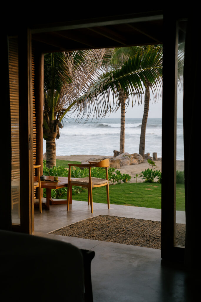 Ocean view from the private terrace of a room at Samas Hotel La Saladita, with palm trees and the beach in the background.