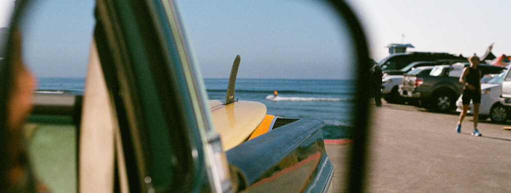 Surf in La Saladita, Guerrero — surfboard on a vintage truck by the beach on Mexico’s Pacific coast.